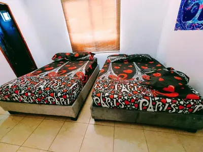 two beds sitting next to each other in a room at Casa Pupo Hostal in Cartagena de Indias