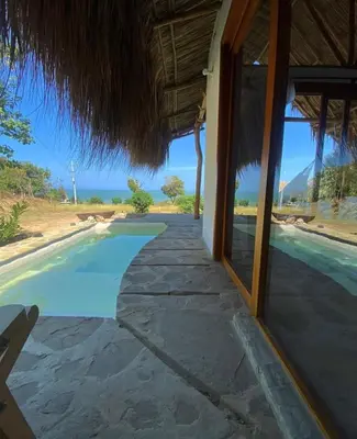 a resort with a swimming pool next to a building at Kamajorú Ecohabitat in Tubará