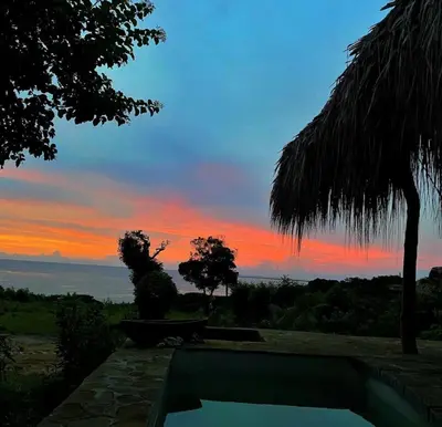 a sunset from a resort with a swimming pool at Kamajorú Ecohabitat in Tubará