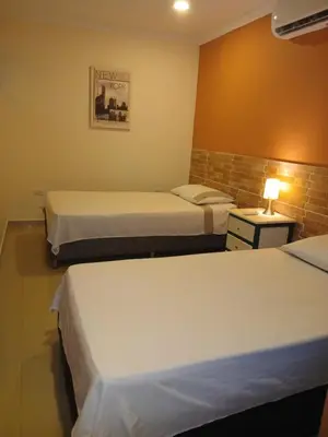 a hotel room with two beds and a lamp at Apto amoblado barrio Los Alpes Cartagena in Cartagena de Indias