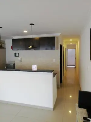 a kitchen with a counter and a long hallway at Apto amoblado barrio Los Alpes Cartagena in Cartagena de Indias