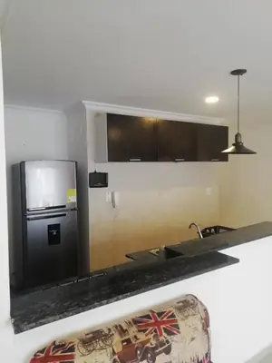 a kitchen with a black refrigerator and a sink at Apto amoblado barrio Los Alpes Cartagena in Cartagena de Indias