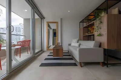 a living room with a white couch and a table at Laurdhomes Laguito Loft Hot Ware 1Bath, lake view in Cartagena de Indias