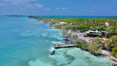 an aerial view of a resort in the water at Medusa Hostel Isla Tintipan in Tintipan Island