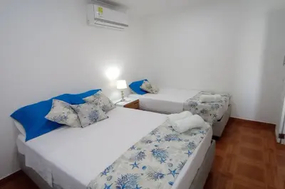 a room with two beds and a couch in it at Hermoso apartamento cerca del centro histórico in Cartagena de Indias