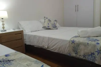 a bedroom with two beds with blue and white sheets at Hermoso apartamento cerca del centro histórico in Cartagena de Indias