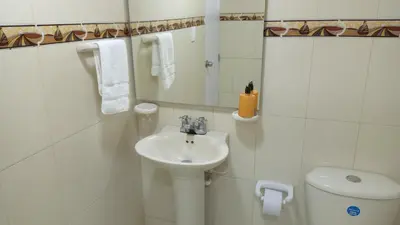 a white bathroom with a sink and a toilet at Hermoso apartamento cerca del centro histórico in Cartagena de Indias