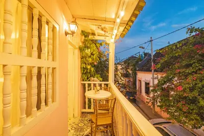 a balcony with a table and a view of a street at CASA HADASA in Cartagena de Indias