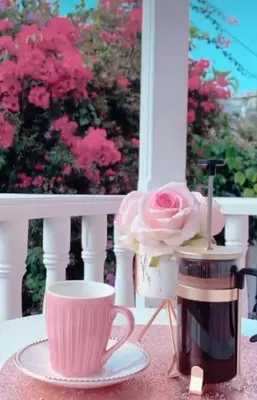 a cup of coffee and a pink rose on a balcony at CASA HADASA in Cartagena de Indias