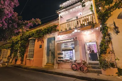 a bike parked in front of a building at night at CASA HADASA in Cartagena de Indias