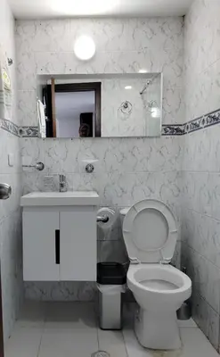 a white bathroom with a toilet and a sink at Cartagena ApartaSuite El Laguito in Cartagena de Indias