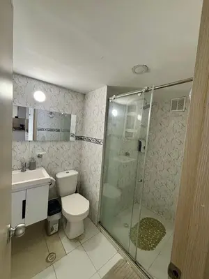 a bathroom with a toilet and a glass shower at Cartagena ApartaSuite El Laguito in Cartagena de Indias