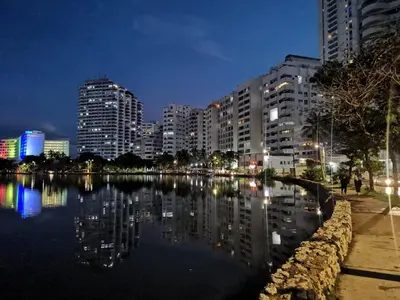 a city at night with a body of water and buildings at Cartagena ApartaSuite El Laguito in Cartagena de Indias