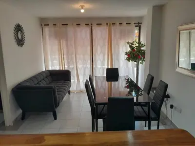 a living room with a table and chairs and a couch at Condominio en la Playa de Crespo in Cartagena de Indias