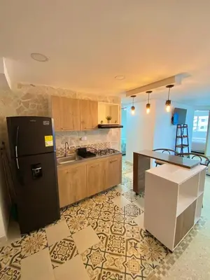 a kitchen with a black refrigerator and a counter at Apartamento frente al mar en Cartagena in Cartagena de Indias
