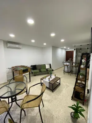 a living room with chairs and a couch and a table at Apartamento frente al mar en Cartagena in Cartagena de Indias