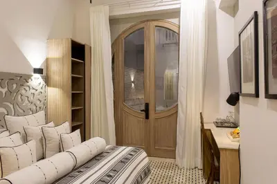 a room with a door and a bed with pillows at Sol de Alba Hotel Boutique in Cartagena de Indias