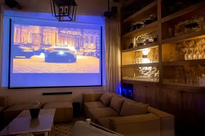 a living room with a large screen with a car on it at Sol de Alba Hotel Boutique in Cartagena de Indias