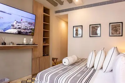a bedroom with a bed with a flat screen tv at Sol de Alba Hotel Boutique in Cartagena de Indias