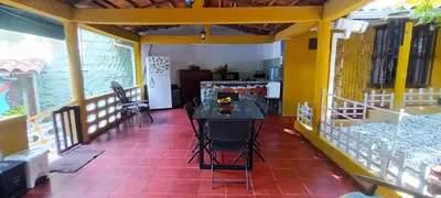 a room with a table and chairs on a balcony at Villa Margarita in Puerto Colombia