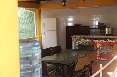a kitchen with a table with chairs and a refrigerator at Villa Margarita in Puerto Colombia