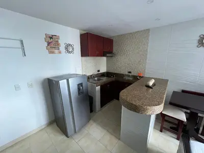 a kitchen with a stainless steel refrigerator and a counter at Alojamientos Cartagena Edificio Atlantis y Conquistador in Cartagena de Indias