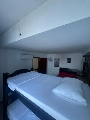 a bedroom with a large white bed in a room at Alojamientos Cartagena Edificio Atlantis y Conquistador in Cartagena de Indias