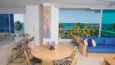 a living room with a table and a blue couch at Magico Apartamento Frente al Mar 4 Habitaciones PAZ345 in Coveñitas