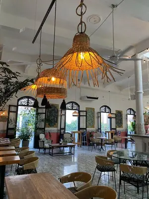 a restaurant with tables and chairs and chandeliers at Al Alma Apart-Suites in Cartagena de Indias