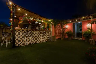 a bar with chairs outside of a restaurant at night at Al Alma Apart-Suites in Cartagena de Indias