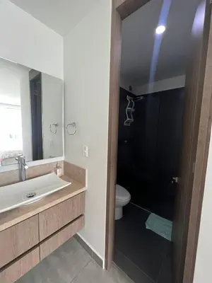 a bathroom with a sink and a toilet and a mirror at Hermoso apartamento con vista al mar y salida directa a la playa in Cartagena de Indias