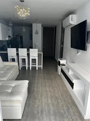 a living room with a couch and a table with chairs at Hermoso apartamento con vista al mar y salida directa a la playa in Cartagena de Indias