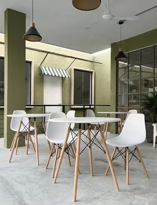 a dining room with white chairs and tables at OASIS TROPICAL HOTEL in Santa Marta