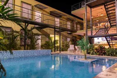 a building with a swimming pool in front of a building at OASIS TROPICAL HOTEL in Santa Marta