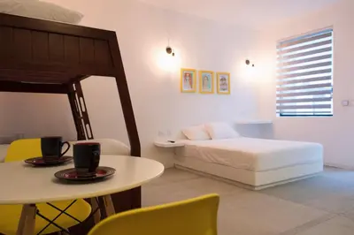 a bedroom with a bed and a table and chairs at OASIS TROPICAL HOTEL in Santa Marta