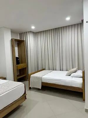 a bedroom with two beds and a window at Hotel El Faro - Desayunos incluidos - Manga, Cartagena in Cartagena de Indias