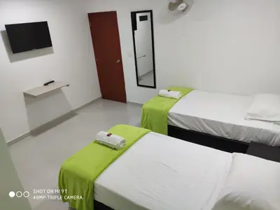 two beds in a room with a mirror and a tv at Hotel Don Jose in Ciénaga