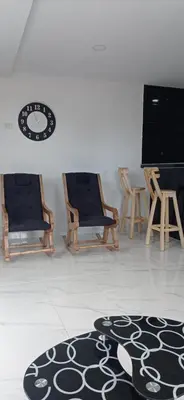 a room with two chairs and a tv and a rug at Hostal-Mirador La Popa in Cartagena de Indias