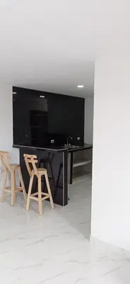 a black desk with two chairs and a large screen television at Hostal-Mirador La Popa in Cartagena de Indias