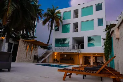 a building with a pool and a bench in front of it at Hotel Caribbean Cartagena in Cartagena de Indias