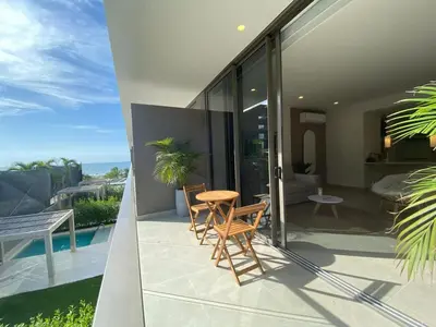 a balcony of a house with a table and chairs at Manzanillo Bay Aparments by Wynwood House in Cartagena de Indias