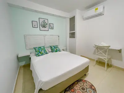 a bedroom with a large white bed in a room at 3CB-2 APARTAMENTO DE 3 ALCOBAS EN EL CENTRO HISTORICO CON AIRE ACONDICIONADO Y WIFI in Cartagena de Indias