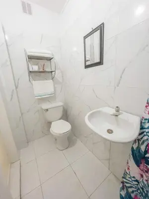 a white bathroom with a toilet and a sink at 3CB-2 APARTAMENTO DE 3 ALCOBAS EN EL CENTRO HISTORICO CON AIRE ACONDICIONADO Y WIFI in Cartagena de Indias