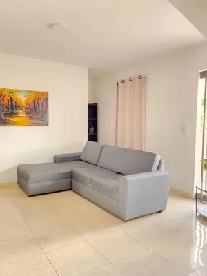 a couch in a living room with a painting on the wall at 3CB-2 APARTAMENTO DE 3 ALCOBAS EN EL CENTRO HISTORICO CON AIRE ACONDICIONADO Y WIFI in Cartagena de Indias