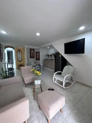 a living room with couches and a flat screen tv at 3CB-1 APARTAMENTO DE 3 ALCOBAS EN EL CENTRO HISTORICO CON AIRE ACONDICIONADO Y WIFI in Cartagena de Indias