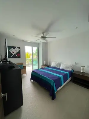 a bedroom with a bed and a ceiling fan at Acogedor apartamento con vista al mar en coveñas in Coveñas