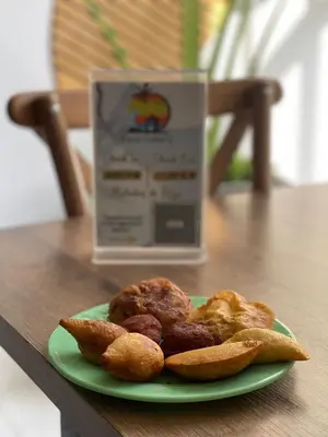 a plate of food on a table next to a box at Casa Colors in Cartagena de Indias