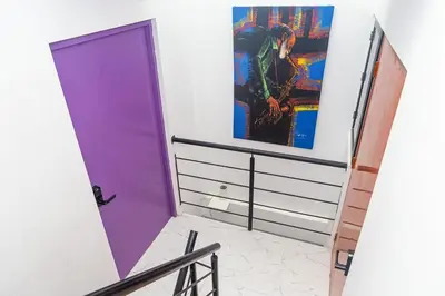a purple door in a room with a painting on the wall at Casa Colors in Cartagena de Indias