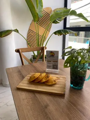 a cutting board with some bread on a table at Casa Colors in Cartagena de Indias