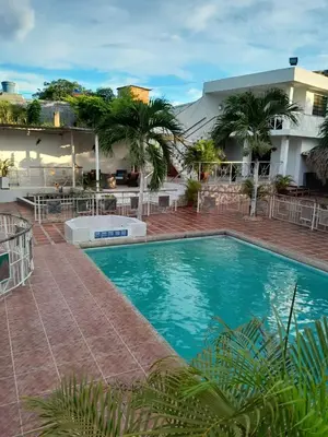 a large swimming pool in front of a hotel at VILLA MARIA in Turbaco
